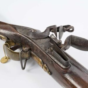 A mid 18th century British brown Bess flintlock musket, the distinctive &#039;banana&#039; shaped lock plate stamped TOWER with a test date of 1743, together with the Royal Cypher for King George II, showing a frizzen with curled toe &amp; feathered frizzen spring, the brass trigger guard fitted with a sling swivel - found again on the pin mounted walnut stock, the .75 caliber smooth bore barrel having a rectangular bayonet lug / front sight, together with a brass mounted ramrod pipe with brass forearm cap. Minor split to muzzle. Overall length: 61&quot;.